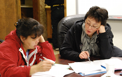 Photo of two school board members working.